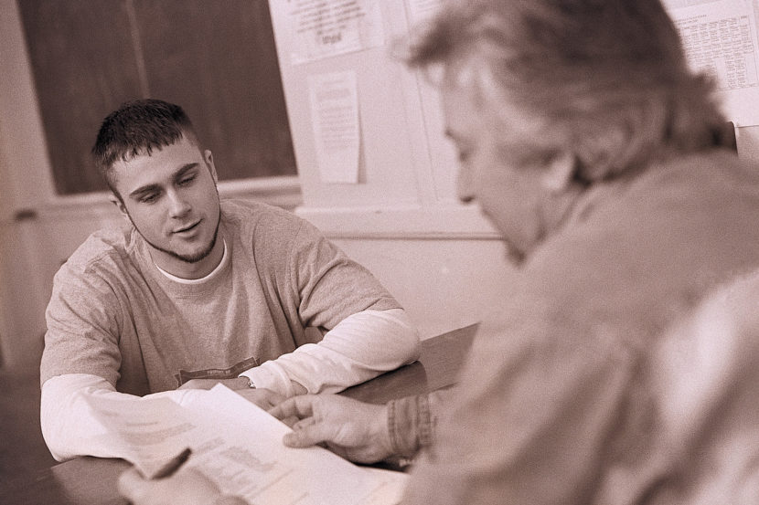 Teacher and Student Discussing Paper