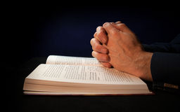 http://www.dreamstime.com/royalty-free-stock-images-clasped-hands-bible-praying-to-god-image29813709